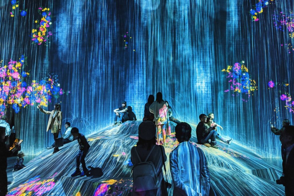 people dancing on stage with blue lights